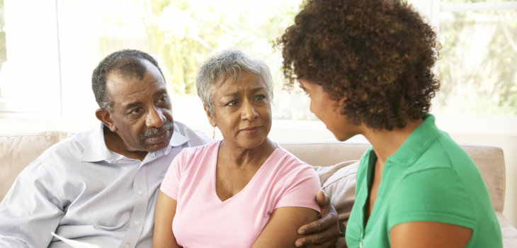 caregiver having conversation with elderly couple